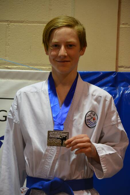 Hamish Johnson with his gold medal won at the inter-regional tournament in Maryborough.