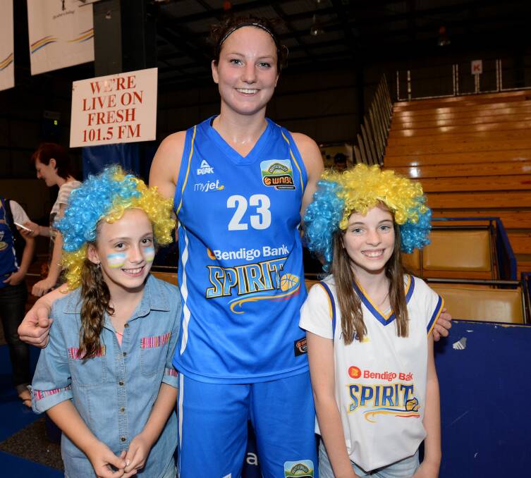 Kelsey Griffin will become an Australian citizen on Sunday. She is pictured with young Spirit fans Mackenzie Cartwright and Chloe Lenaghan after a Spirit game in 2014. Picture: JIM ALDERSEY