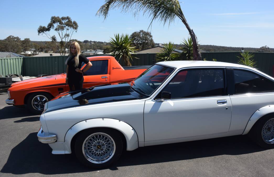 FOOD DRIVE: Show Off Your Pride and Joy co-organiser Maddie McCartin stands alongside two Toranas. Picture: JASON WALLS