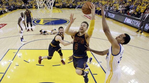 Matthew Dellavedova drives to the basket past Golden State Warriors' Shaun Livingston in game 1 of the NBA finals in June. Photo: AP
