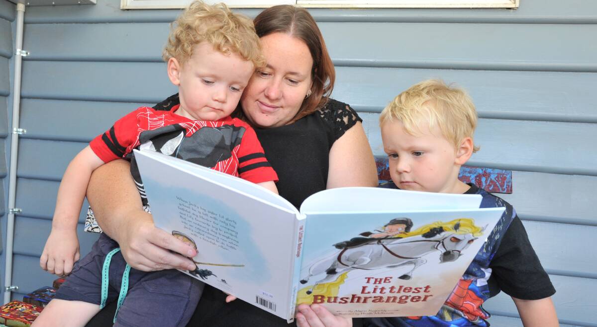 A GOOD READ: Eaglehawk mother Brooke Benbow has joined the library program with her two boys, Noah and Kobei Benbow. Picture: NONI HYETT