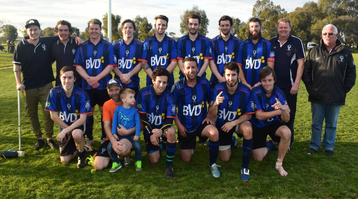 Eaglehawk players ad officials gather after they clinched a hard fought 1-0 win against Epsom to capture the Bendigo Amateur Soccer League men's championship crown. Picture: KIERAN ILES