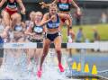 Bendigo University's Abbey Reid lands in the water race on her way to bronze in the  under-17 2000m steeplechase on Wednesday. Picture by Scott Sidley