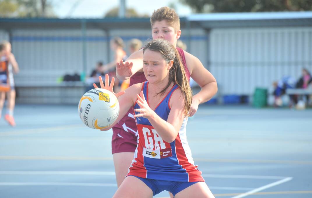 PRESSURE: Pyramid Hill's Zoe Kennedy takes possession of the ball under the guard of Megan Jennings. Picture: ADAM BOURKE