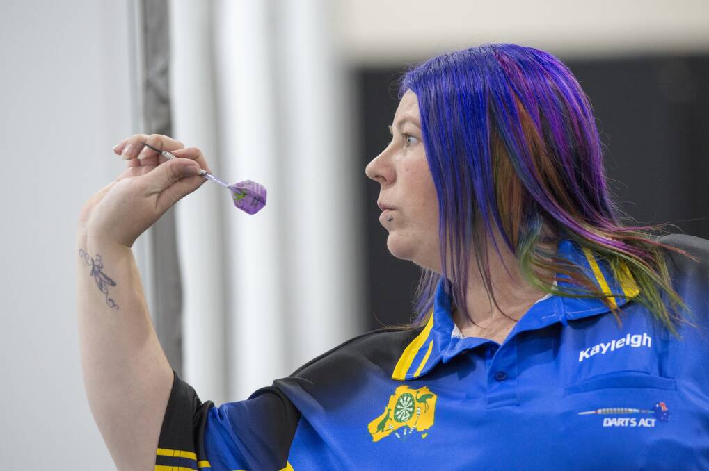 GETTING DOWN TO BUSINESS: Kayleigh Johnson is a picture of concentration, representing the ACT on day one of the Australian Darts Championships. Picture: DARREN HOWE