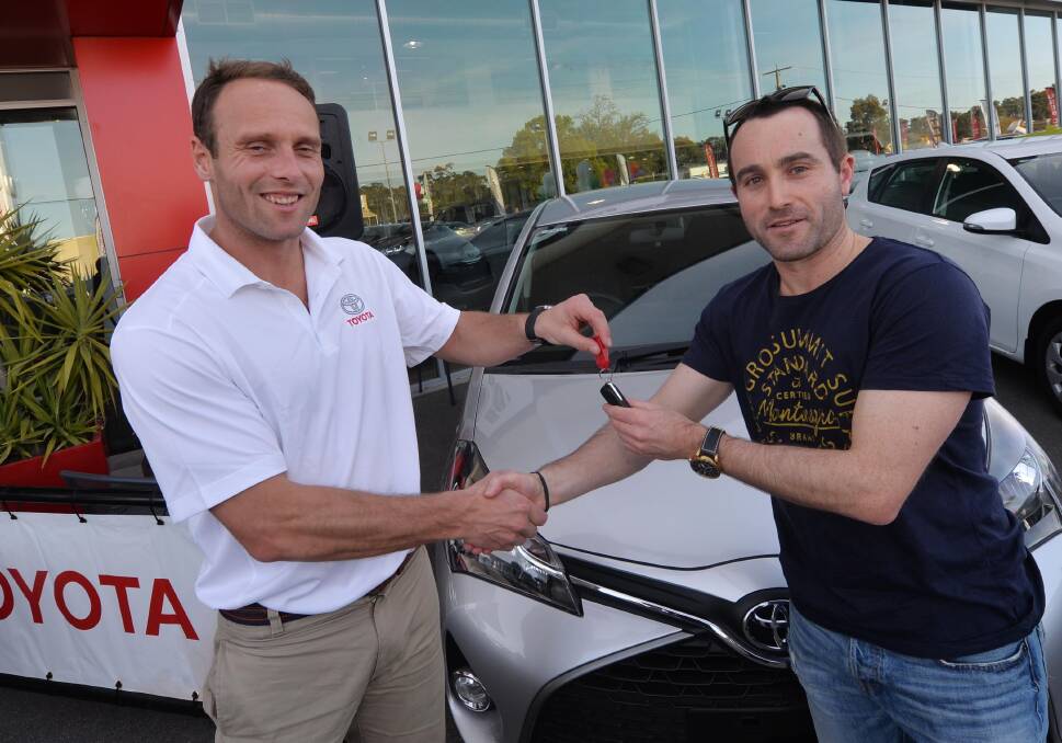 MAJOR WIN: Ben Noonan scores the keys to his new Yaris from former Hawks star Brad Sewell. Picture: DARREN HOWE