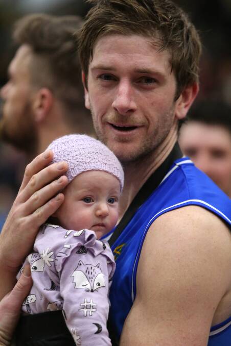 Chris Hogan celebrates the Braves' east conference grand final win with daughter Grace. Picture: GLENN DANIELS