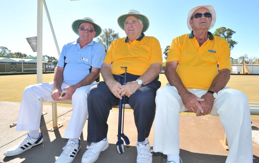 Chris Lewis, Dick Jones and Roger Spence await their turns on the greens at the Kangaroo Flat Bowls Club. Pictures: NONI HYETT