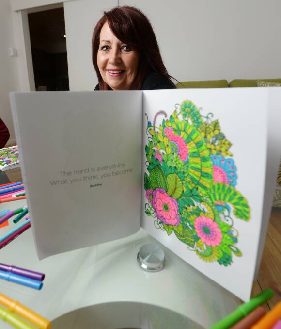BETWEEN THE LINES: Bendigo woman Leonie Walker finds colouring books to be therapeutic. Picture: DARREN HOWE. 