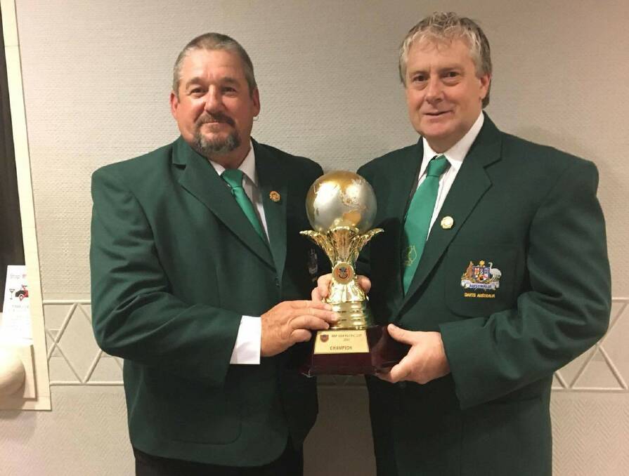 PROUD MOMENT: Bendigo's Justin Thompson (right) and his gold medal winning doubles partner Adam Rowe with the Asia-Pacific Cup trophy the Australian team won in Japan.