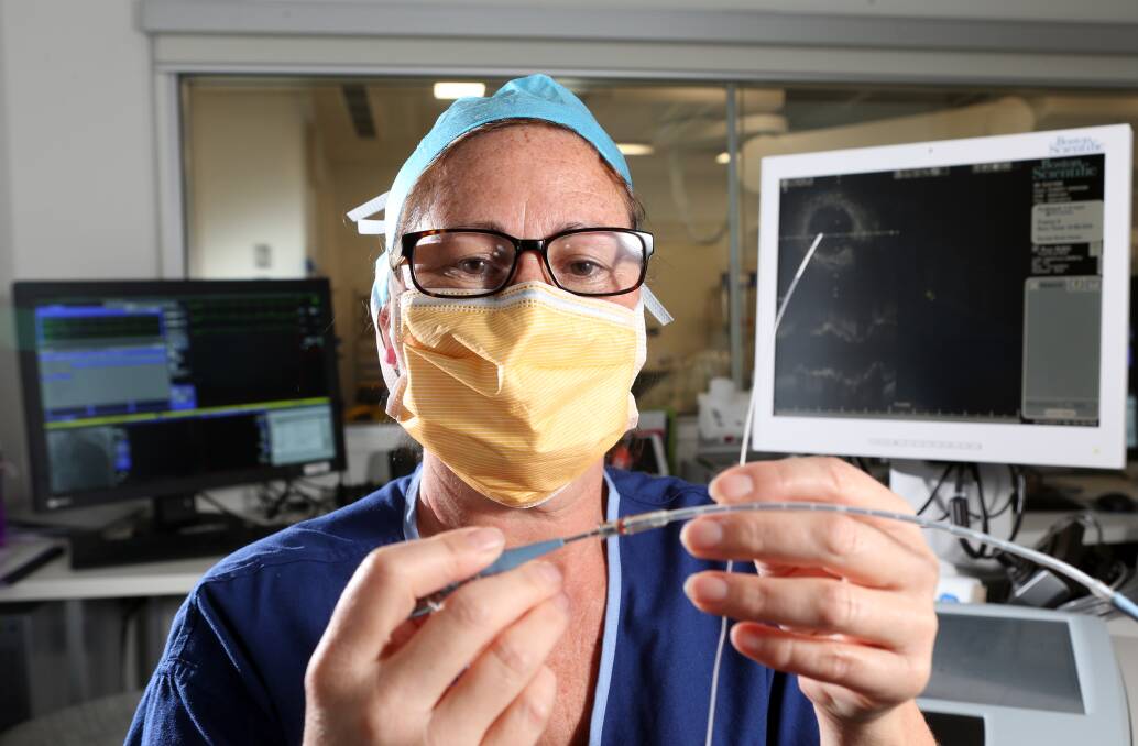 TINY DEVICE: Bendigo Health's Michelle Lloyd with the minuscule coronary imaging catheter. Picture: GLENN DANIELS
