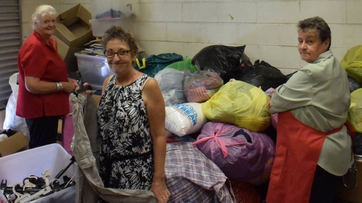 SORT IT OUT: Volunteers Brenda Long, Michelle Gill and Judy Scott sort through clothes donated to the Salvation Army op shop on Eaglehawk Rd. Picture: MARK KEARNEY