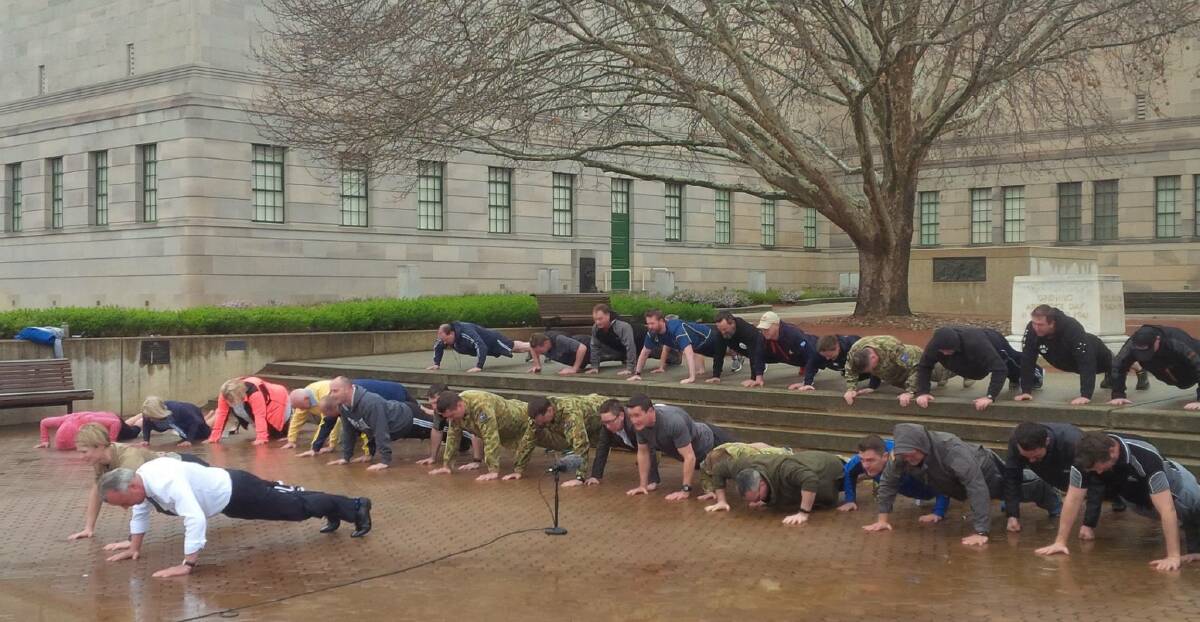 HARD WORK: Australian War Memorial director Dr Brendan Nelson leads a push-up challenge outside the Canberra landmark. Picture: CONTRIBUTED