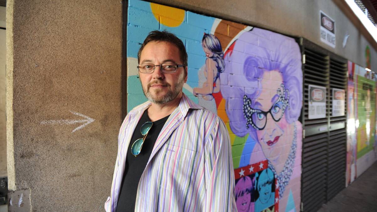 COLOURED IN: Chris Duffy, aka Hackney Hockney, shows off his latest pop art mural in Chancery Lane. The walkway is almost full of street art, leaving creatives to look elsewhere for space. Picture: NONI HYETT
