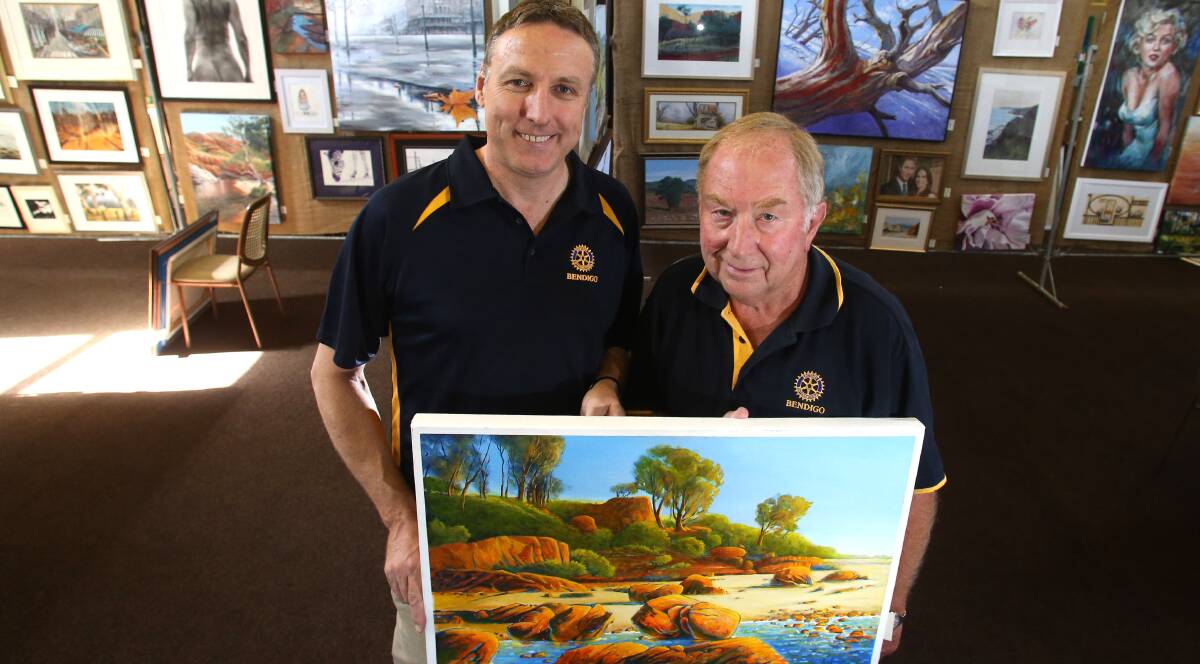 GALLERY: Brian Figg and Des Samson prepare the Rotary Easter Art Show at the Bendigo Town Hall. Picture: GLENN DANIELS