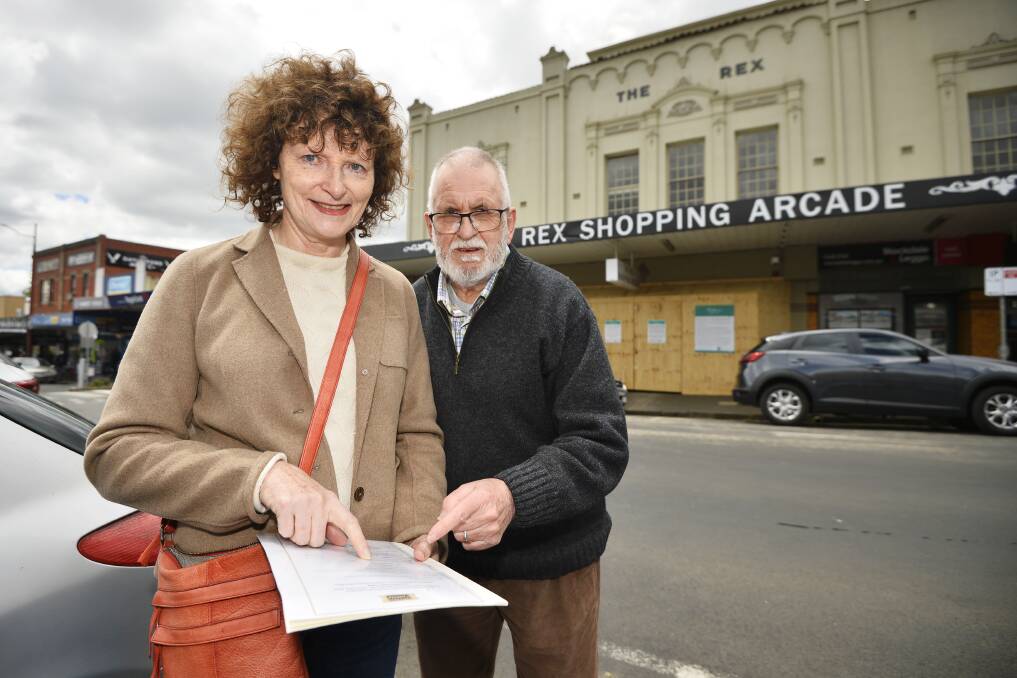 POP-UP: Daylesford Cinema president Gina Lyons and volunteer Glen Heyne plan for the pop-up theatre outside the closed Rex Shopping Arcade. Picture: Dylan Burns 
