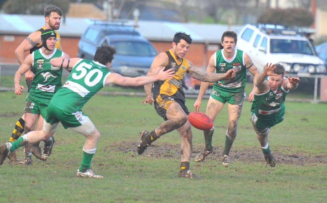 POWER PLAY: In-form Kyneton midfielder Hamish Govan pounds the ball out of defence against Kangaroo Flat on Saturday. Picture: LUKE WEST