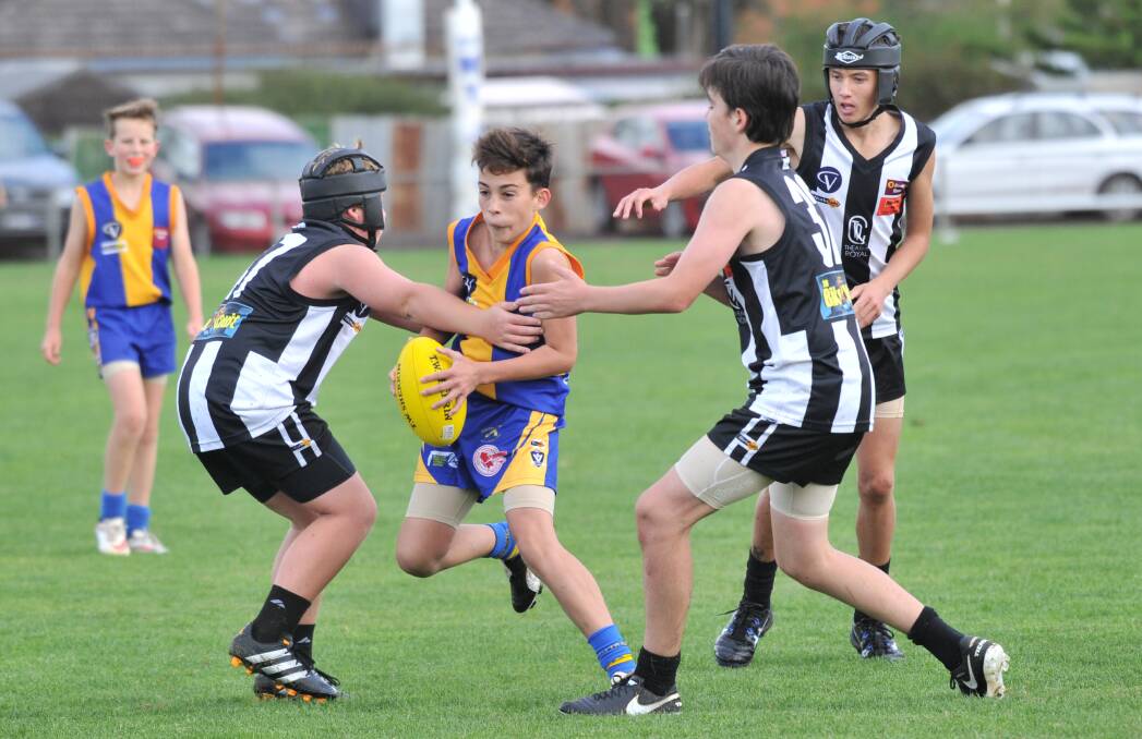 TOUGH BATTLE: Action from the Golden Square versus Castlemaine under-14 clash on Sunday. Picture: NONI HYETT