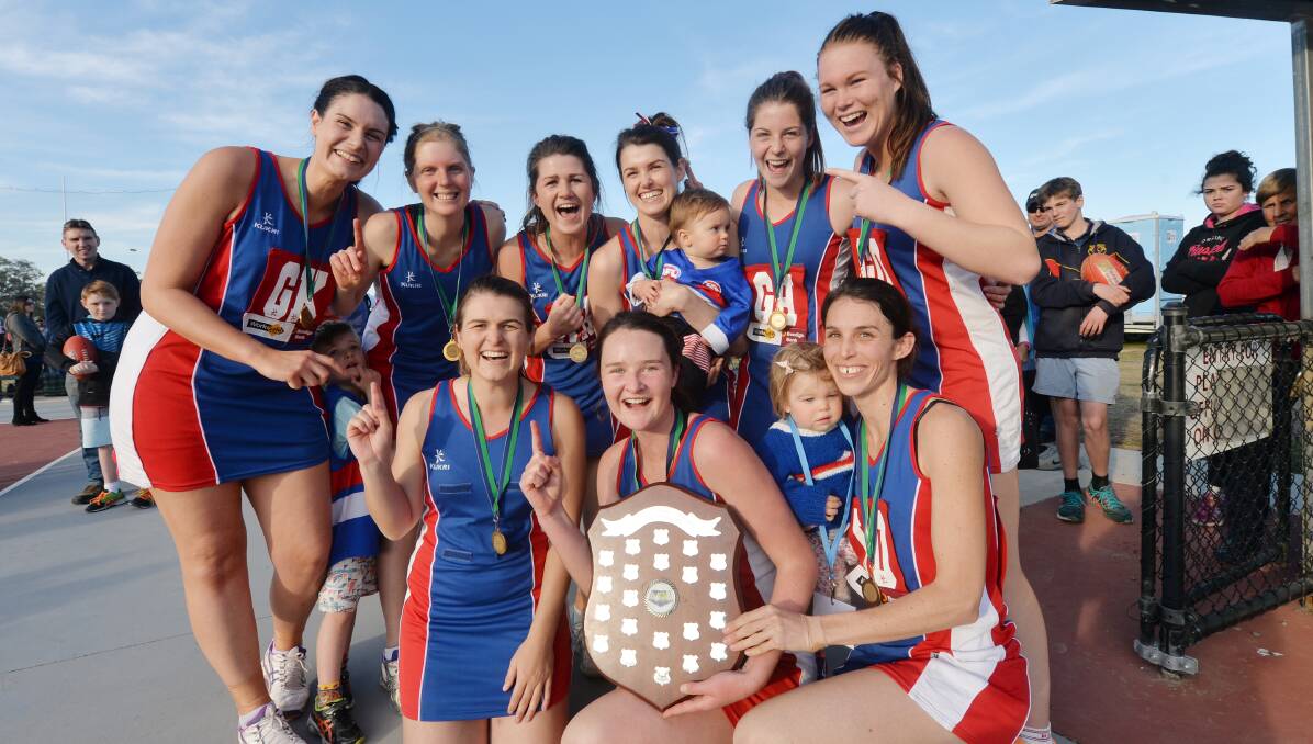 TOP OF THE POPS: Pyramid Hill's A-grade netball team celebrates its premiership win. Picture: DARREN HOWE 