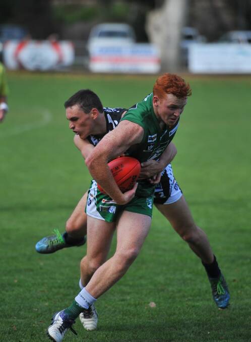 SMOOTH MOVER: Kangaroo Flat's Ryley Barrack tries to break a tackle in the Roos' 45-point win over Castlemaine on Sunday. Picture: ADAM BOURKE