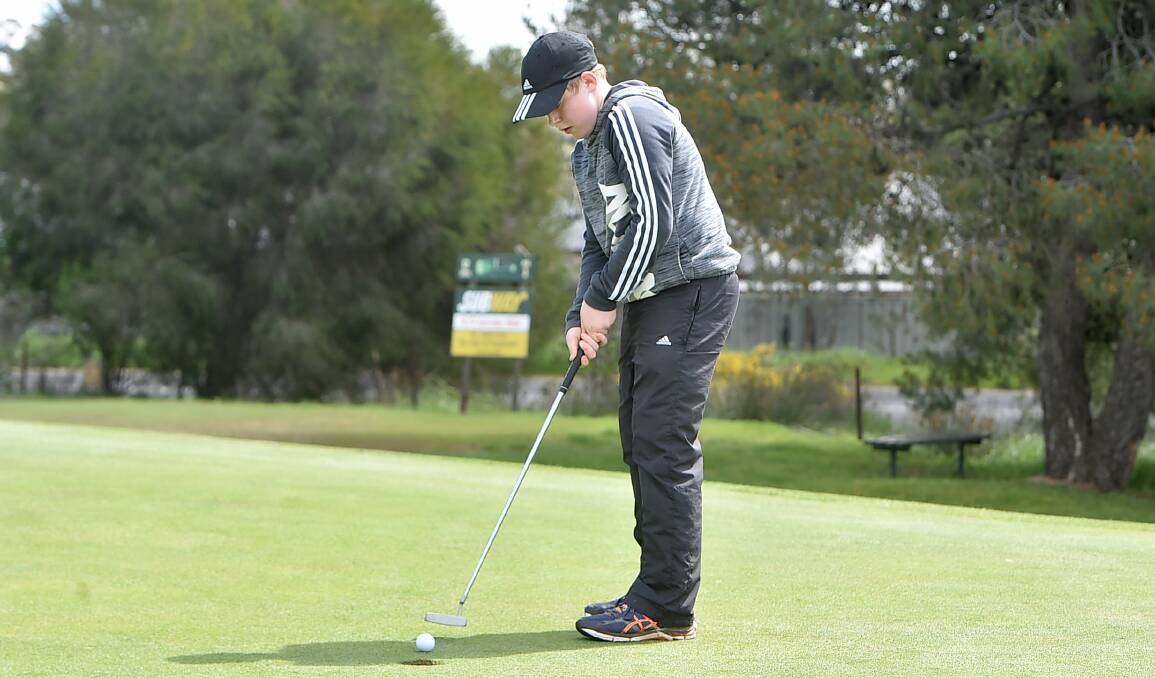 IN THE HOLE: Thomas Chisholm sinks a putt during his round for Neangar Park at the Goldfields Cup. Picture: NONI HYETT