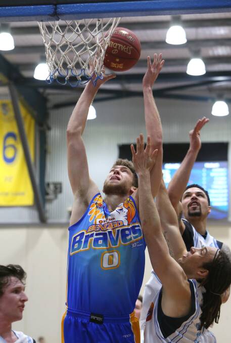 INSPIRED: Michael Vigor scores two of his 29 points in Sunday's game against Hobart. Picture: GLENN DANIELS