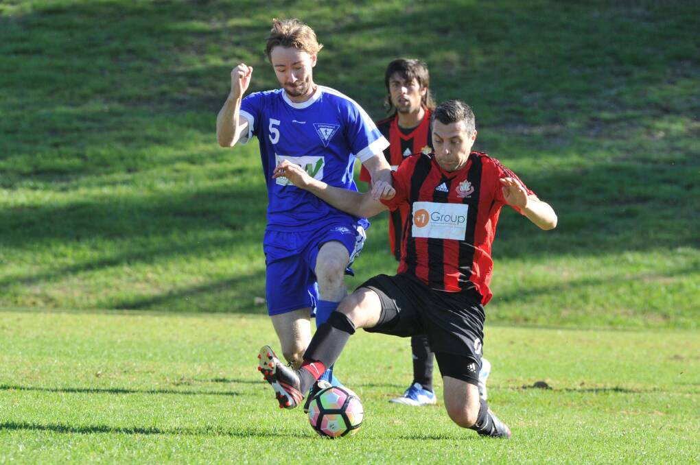 Shepparton Soccer Club (red and black) in action against Strathdale earlier this season.
