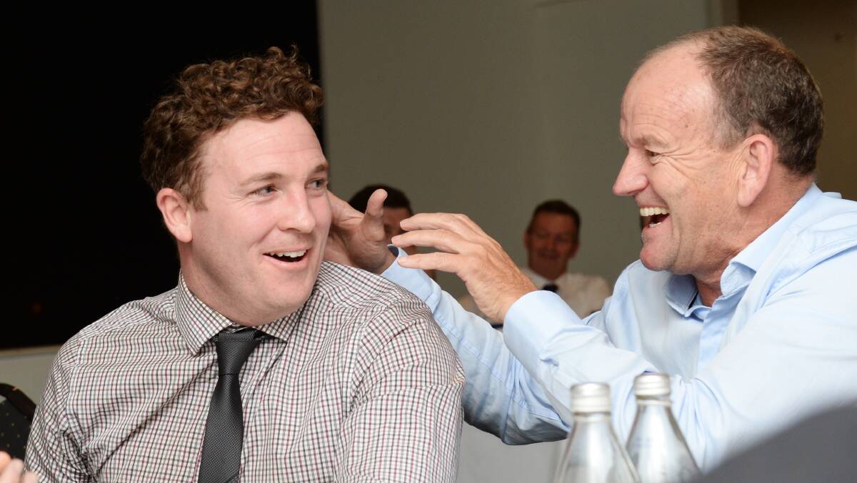 Kristan Height is congratulated by Sandhurst coach Wayne Primmer after he won the Michelsen Medal. Picture: DARREN HOWE