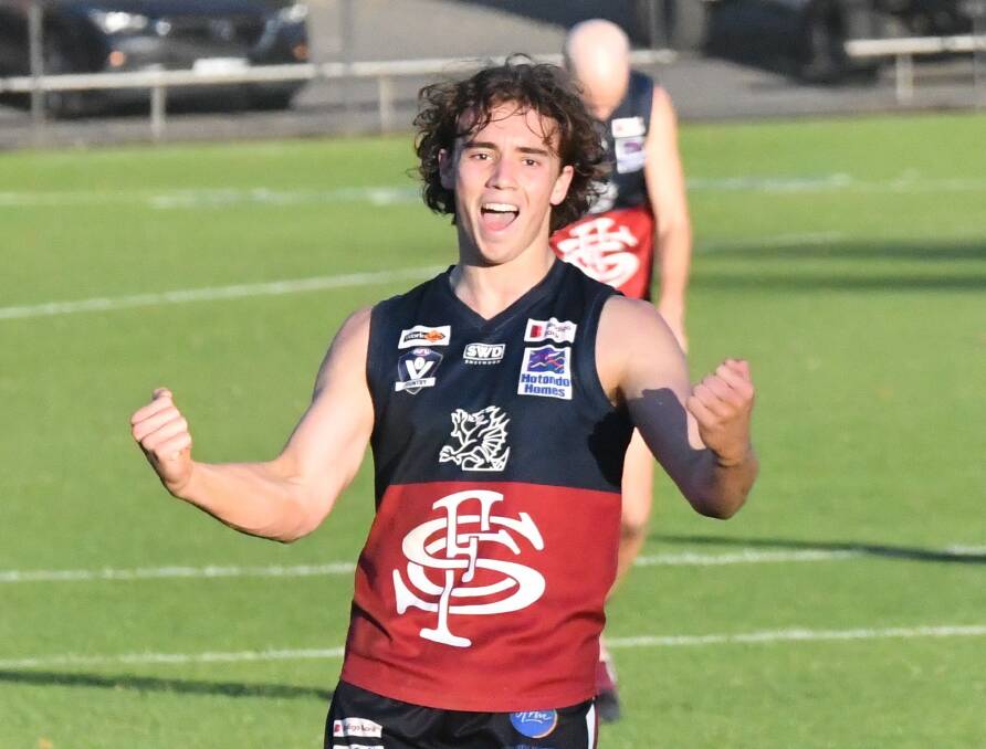 Ollie Hannaford celebrates after kicking his first goal for Sandhurst in senior football. Picture by Adam Bourke