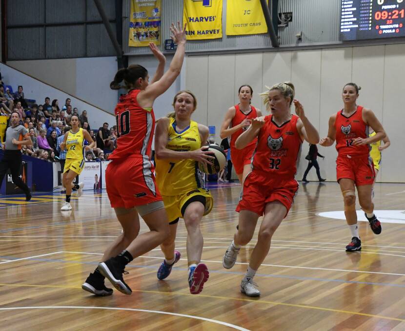 TWO ON ONE: Bendigo Spirit guard Heather Oliver splits the Perth defence in Friday night's loss at Bendigo Stadium. Picture: LUKE WEST