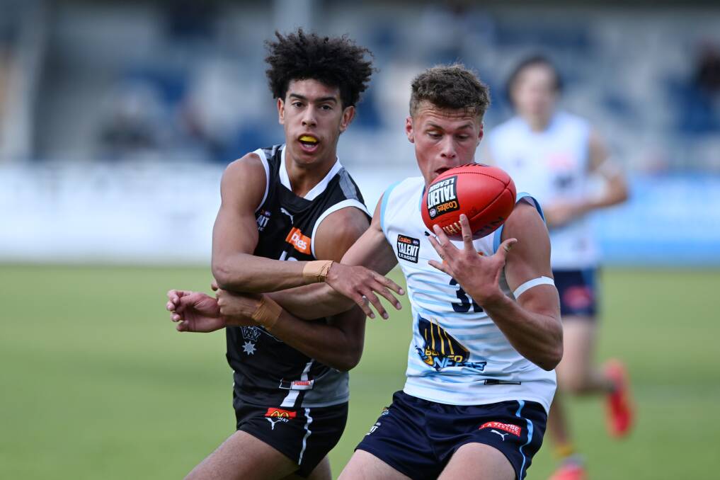 Bendigo Pioneers' Angus Scoble tries to gather the footy against the Rebels. Picture by Kate Healy