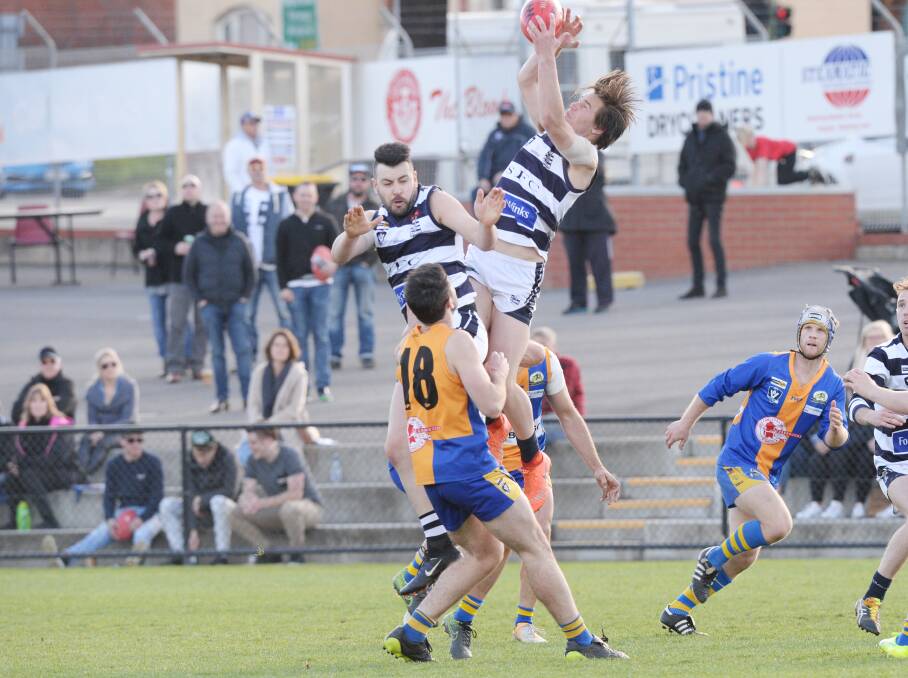 UP AND ABOUT: Strathfieldsaye teenager Lachlan Wallace climbs high to take a mark in the second quarter of Saturday's preliminary final. Picture: DARREN HOWE