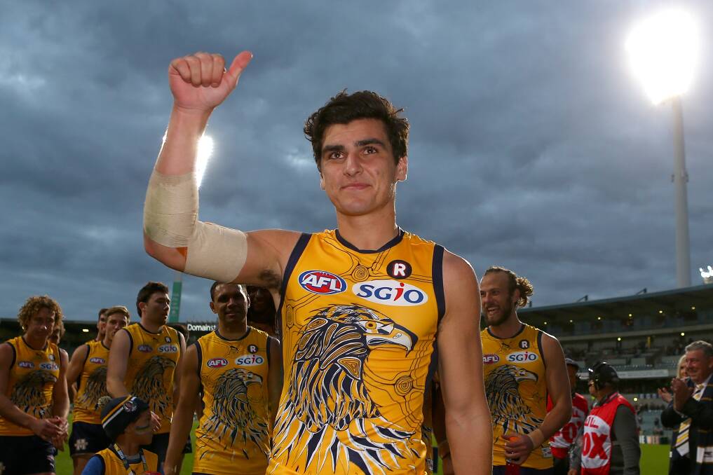 Tom Cole salutes the crowd as he leads the West Coast Eagles off the ground. Picture: GETTY IMAGES