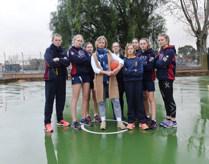 UNFAIRLY TREATED: Cath Robertson with Sandhurst junior netballers who get changed behind trees at the QEO. Picture: DARREN HOWE 