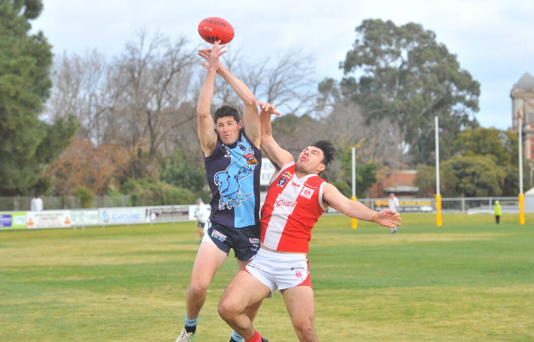 CONTESTED BALL: Eaglehawk's Brenton Conforti tries to mark in front of South Bendigo's Alex Hywood. Picture: ADAM BOURKE