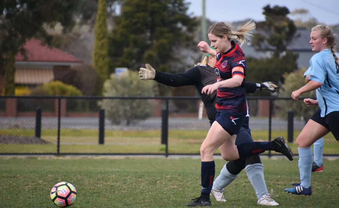 OUT OF MY WAY: Epsom captain Paige Gordon powers past the Swan Hill defence to score one of her two goals. Picture: LIZ GRACO