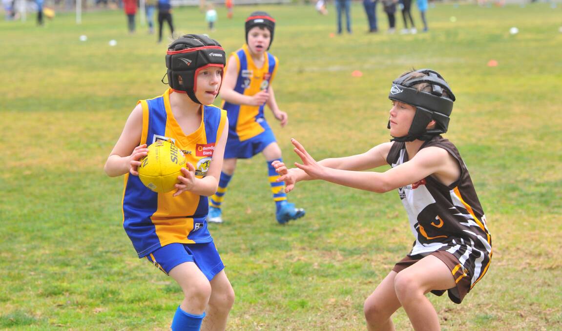 FOOTY ROOKIES: Golden Square and Huntly under-9 players had plenty of fun in their game at California Gully on Saturday. Picture: ADAM BOURKE