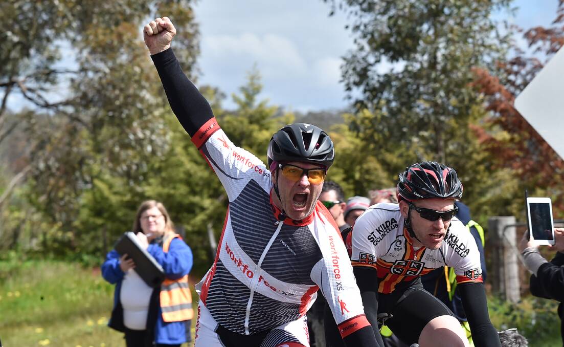 Bendigo's Noel Hughes punches the air in triumph after winning the Rob Vernon Memorial road race on Sunday. Picture: NONI HYETT