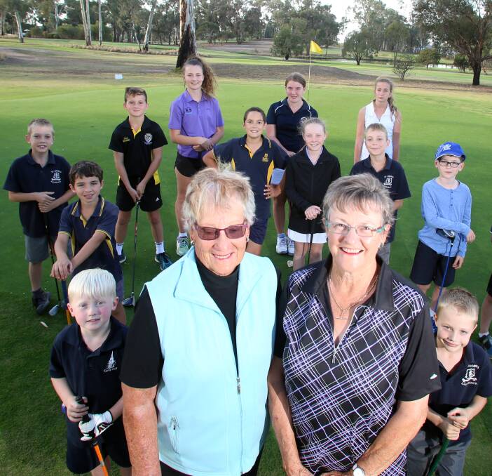 IN THE SWING: Yvonne Boyd and Jan Conder with some of their junior golf prodigies at Neangar Park Golf Club. Picture: GLENN DANIELS