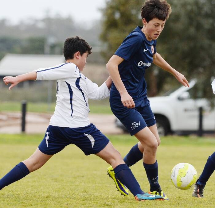 ATTACKING MOVE: Bendigo City FC under-14 player Kayle Thompson works past the Brunswick City defence. Picture: DARREN HOWE