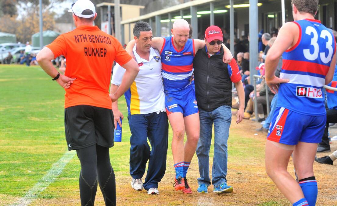 Tyson Findlay is helped from the ground after straining his hamstring in the second quarter of the preliminary final. Picture: ADAM BOURKE