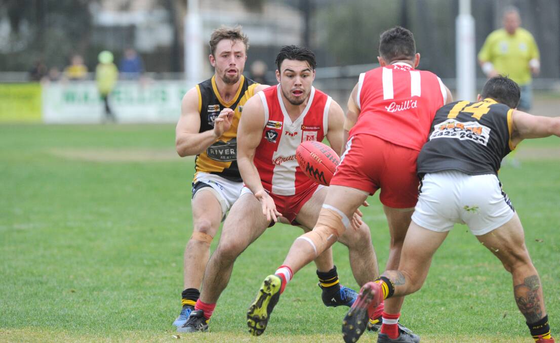 IN FRONT: South Bendigo's Alex Hywood grabs possession of the ball in Saturday's two-point win over Kyneton. Picture: NONI HYETT