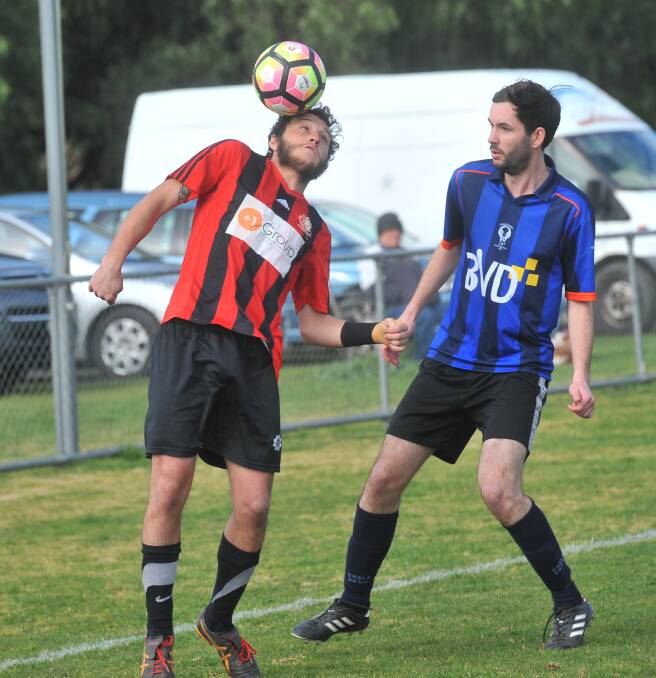 HEAD FIRST: Shepparton's Giacomo Alvisi controls the ball ahead of Eaglehawk defender Chris Hopley at Truscott Reserve on Sunday. Picture: ADAM BOURKE