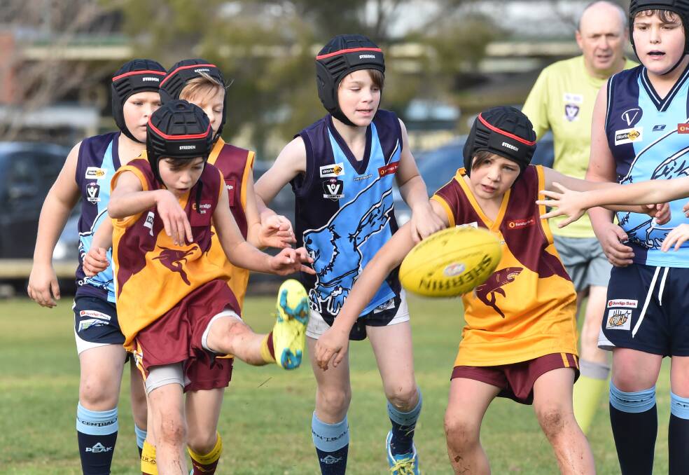 HARD BALL GET: Action from the St Therese's versus Eaglehawk under-12 match at Ewing Park on Saturday. Picture: GLENN DANIELS