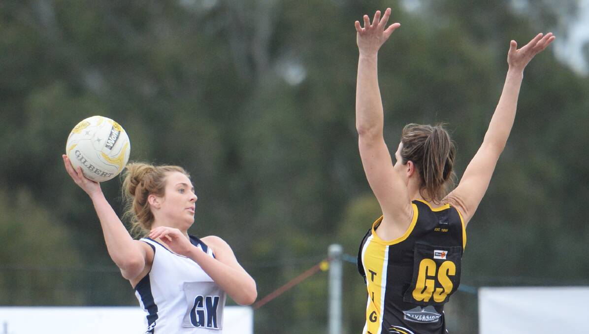 PRESSURE ON: Strathfieldsaye goal keeper Claudia Powell tries to pass the ball clear of Kyneton's Michelle Fletcher. Picture: DARREN HOWE