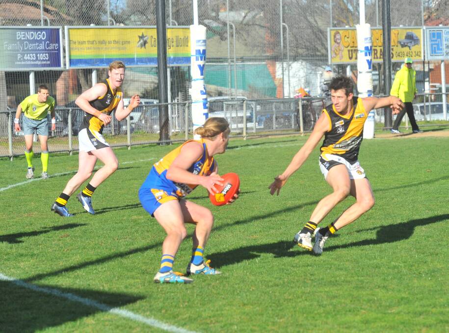 Golden Square's Harry Donegan tries to get past Kyneton's Rhys Magin.