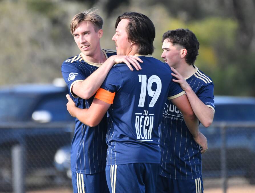 Kayle Thompson is congratulated by team-mates after scoring Bendigo City's goal. Picture by Adam Bourke