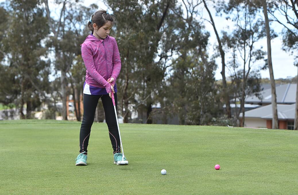 SLICK PUTT: Elyssa Amor-Atkinson watches her putt carefully during the Goldfields Cup. Picture: NONI HYETT