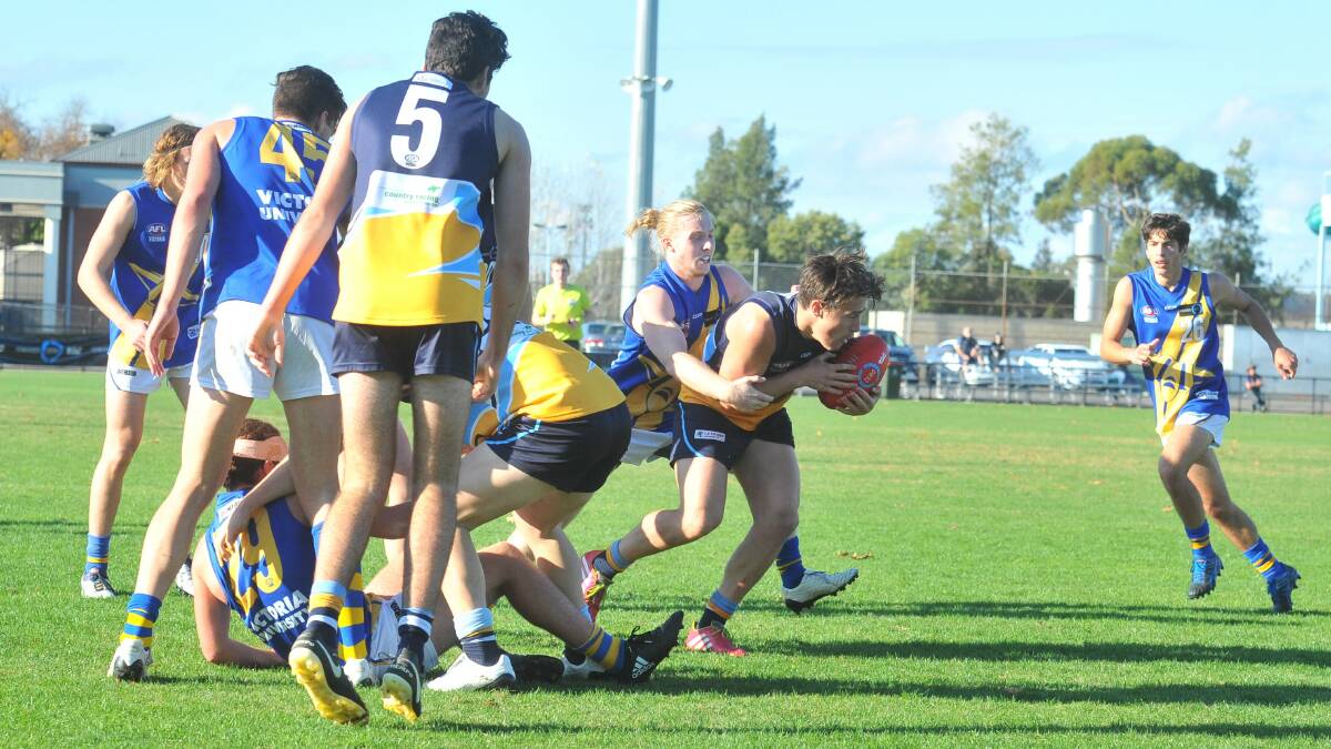 CONTESTED POSSESSION: Bendigo Pioneers midfielder Wade Donnan tries to break clear from a pack against the Western Jets.
