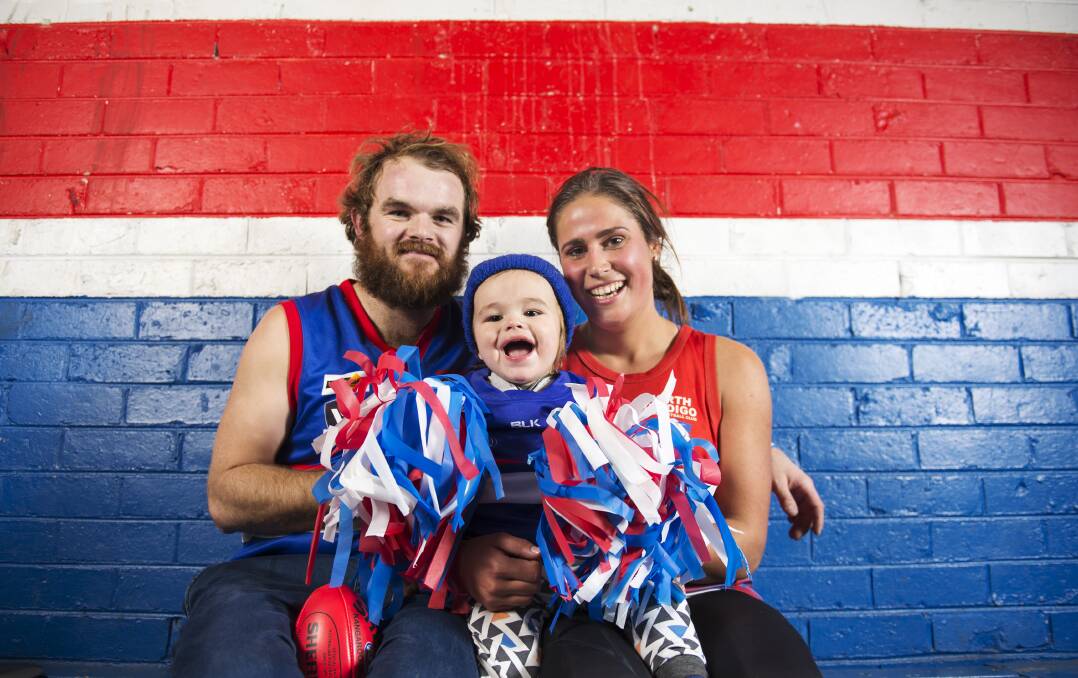 Ryan and Kristie Alford with their biggest fan - their son Hudson. Ryan and Kristie will play for North Bendigo in footy and netball grand finals on Saturday. Picture: DARREN HOWE